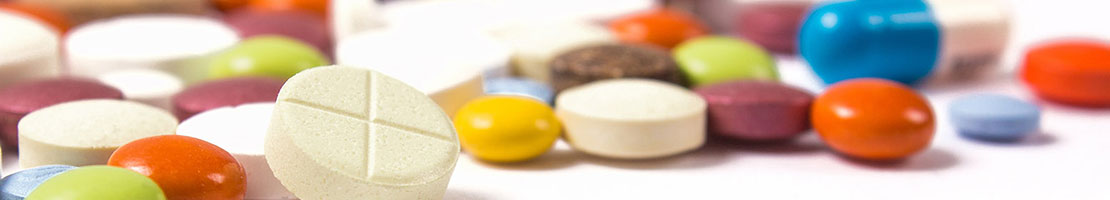 Various medications scattered across table. 